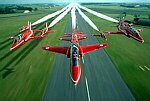 Photography of Red Arrows in formation flying down the runway
