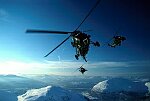 Photography of Royal Navy Wessex helicopters flying over mountains in the arctic