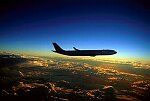 Photography of A340 aircraft flying above cloud at dusk