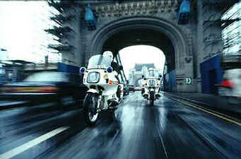 Police motor bikes over Tower Bridge