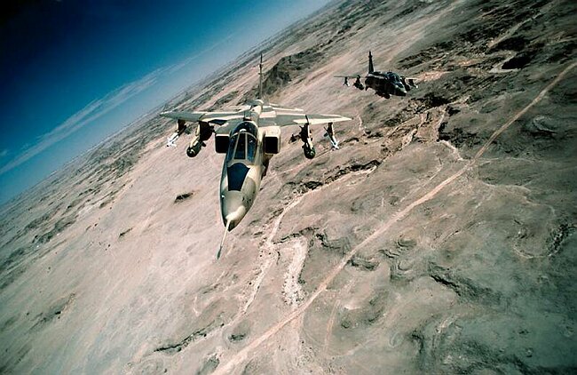 Jaguar aircraft flying across the desert