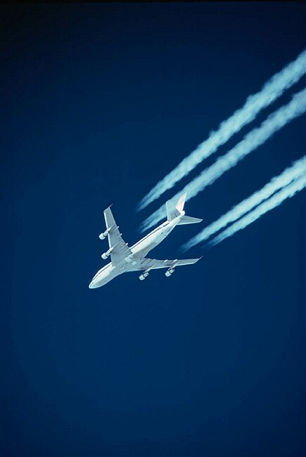 Jumbo jet with contrails.