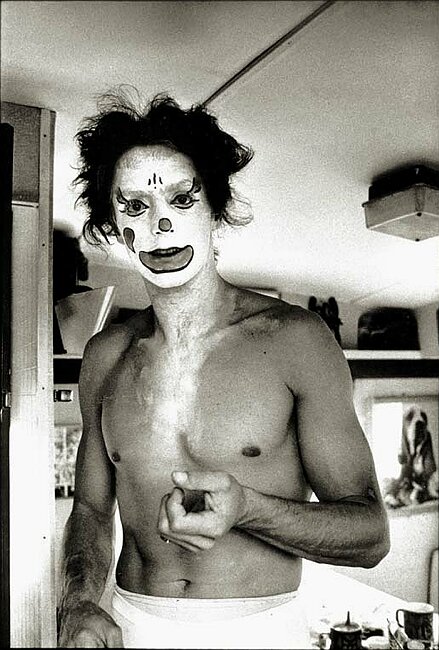 Trapeze artist in white face.